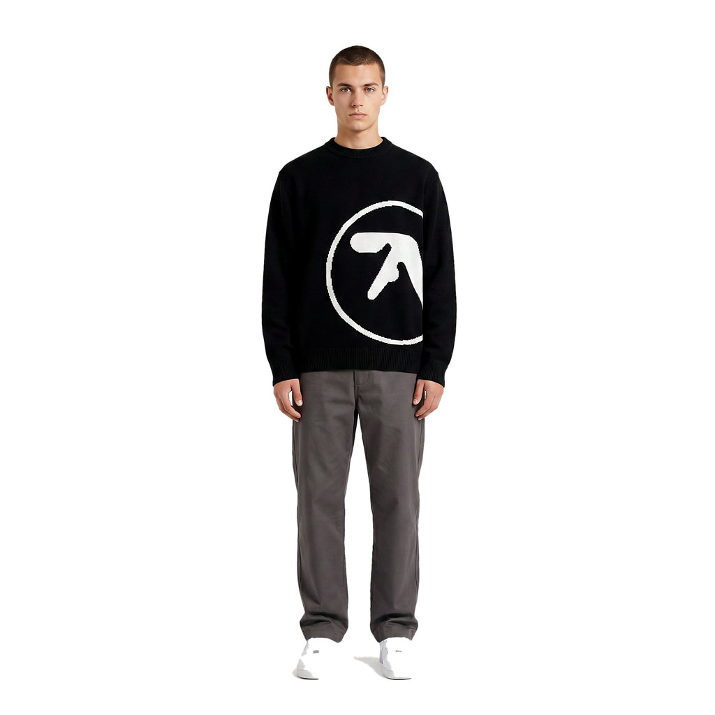 Model wearing the oversized knit graphic sweater in black