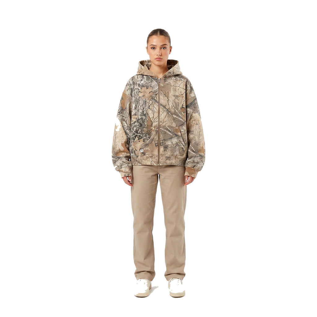 Female model wearing the camo oversized zip-up hoodie