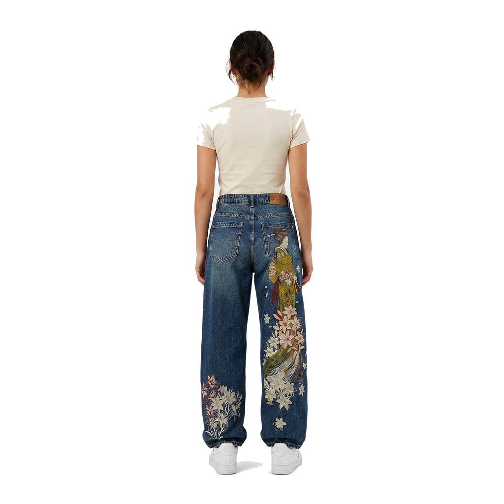Female model in Sleepy Apparel embroidered baggy wide-leg Y2K jeans, light wash