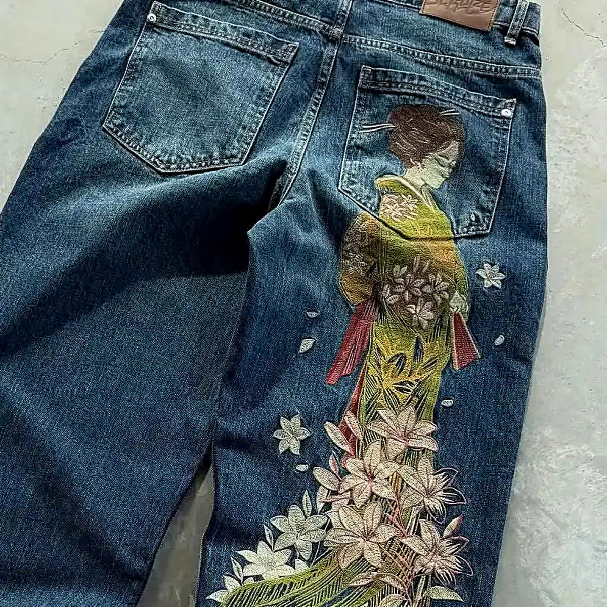 Embroidered baggy wide-leg Y2K denim jeans — raised-thread embroidery, product view
