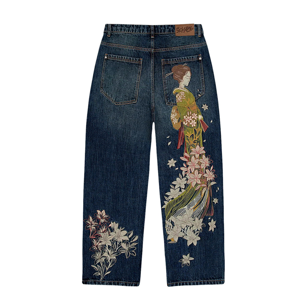 Embroidered baggy jeans in indigo wash — kimono figure and trailing lily embroidery down the back of wide-leg Y2K denim