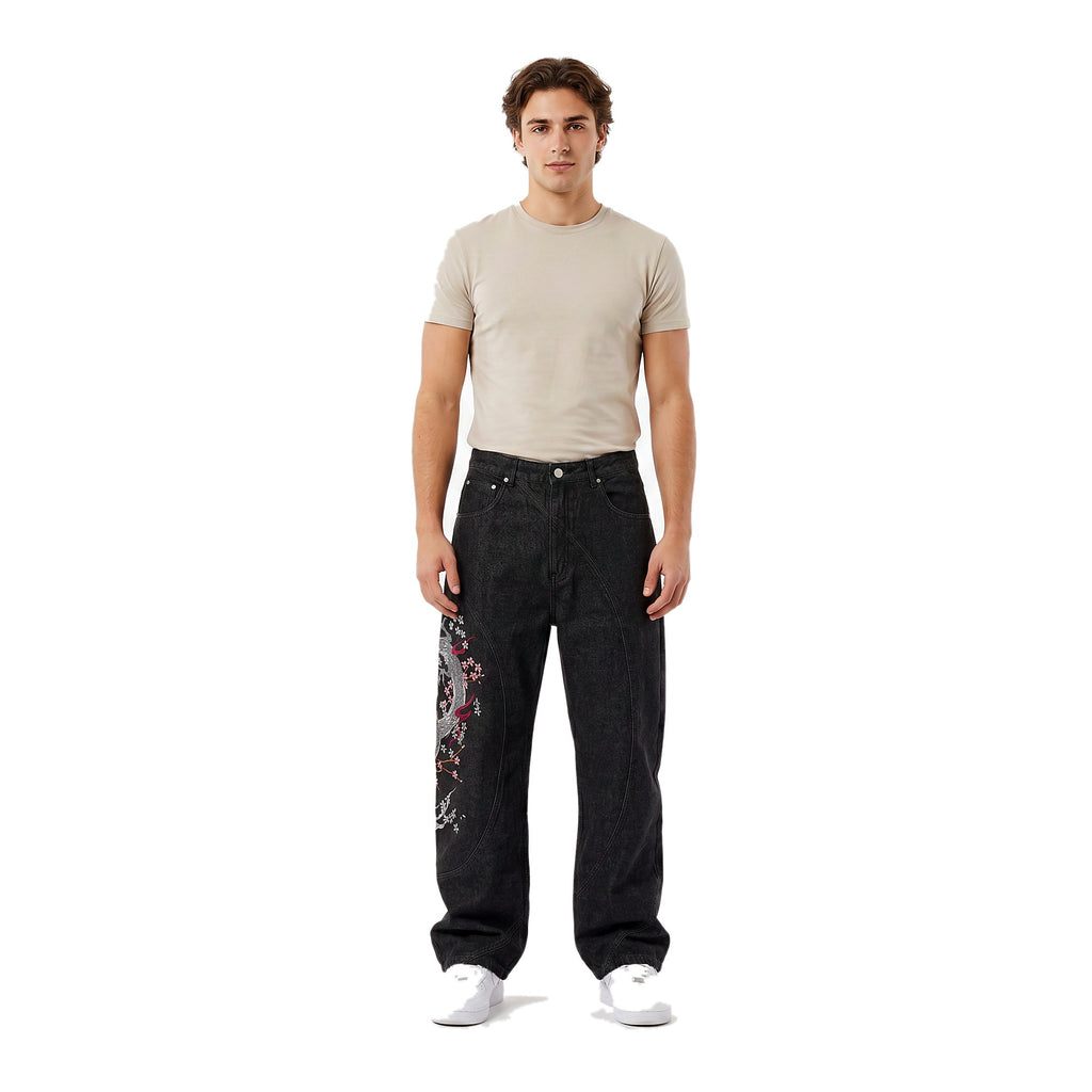 Man wearing embroidered wide-leg baggy jeans in a dark wash