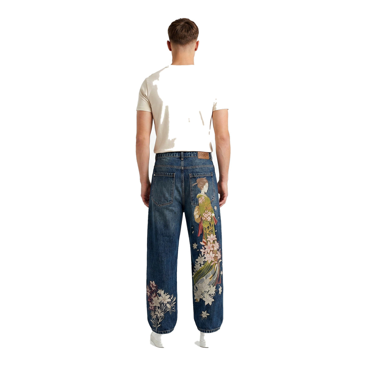 Back view of embroidered baggy Y2K jeans in a mid-tone wash