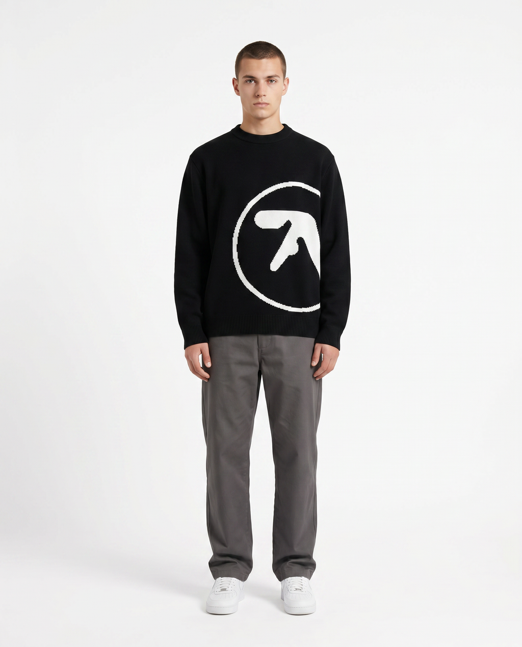 Model wearing the oversized knit graphic sweater in black