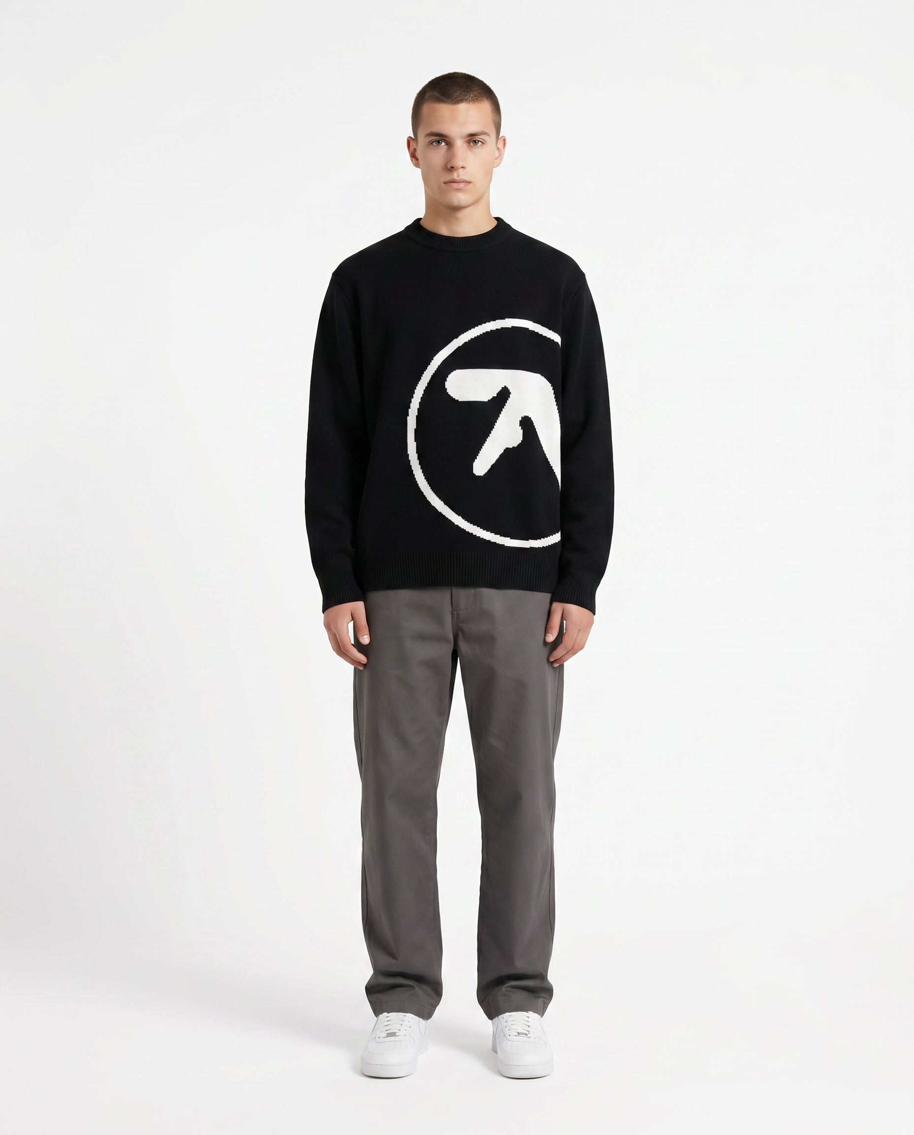 Model wearing the oversized knit graphic sweater in black