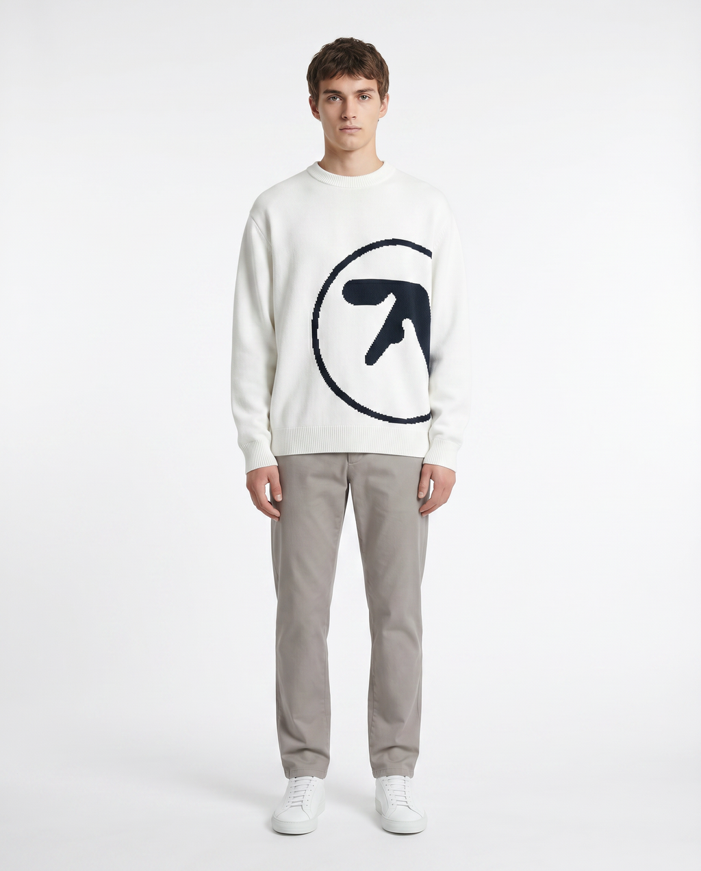 Model wearing the oversized knit graphic sweater in white