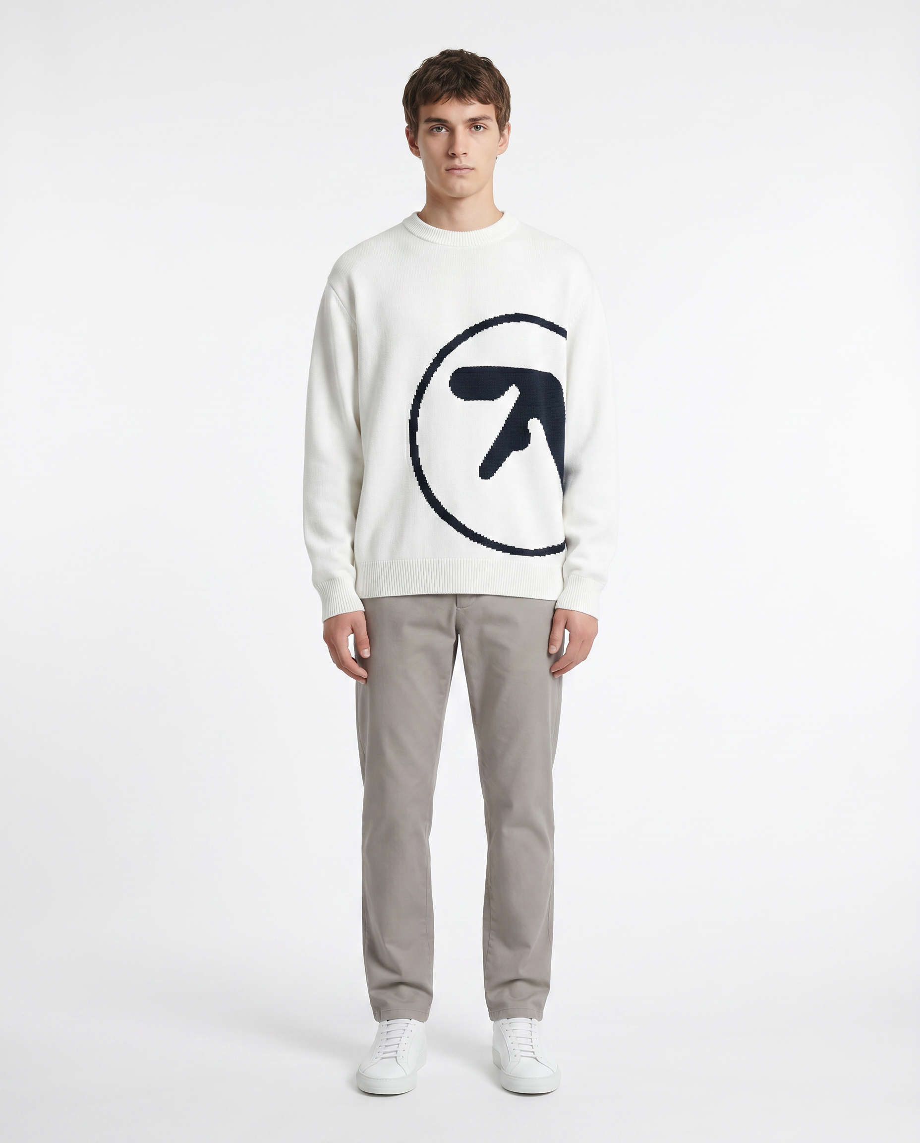 Model wearing the oversized knit graphic sweater in white