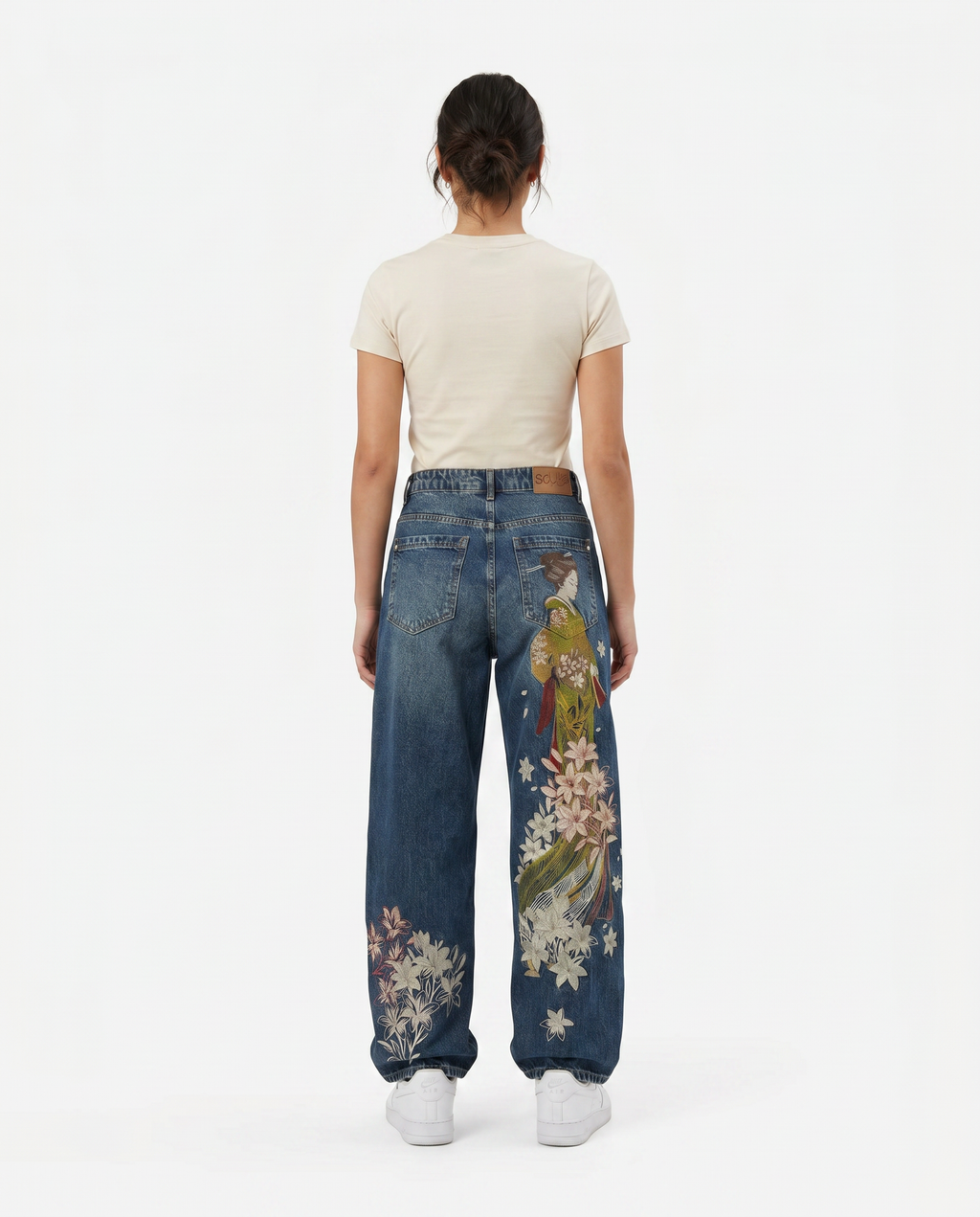 Female model in Sleepy Apparel embroidered baggy wide-leg Y2K jeans, light wash