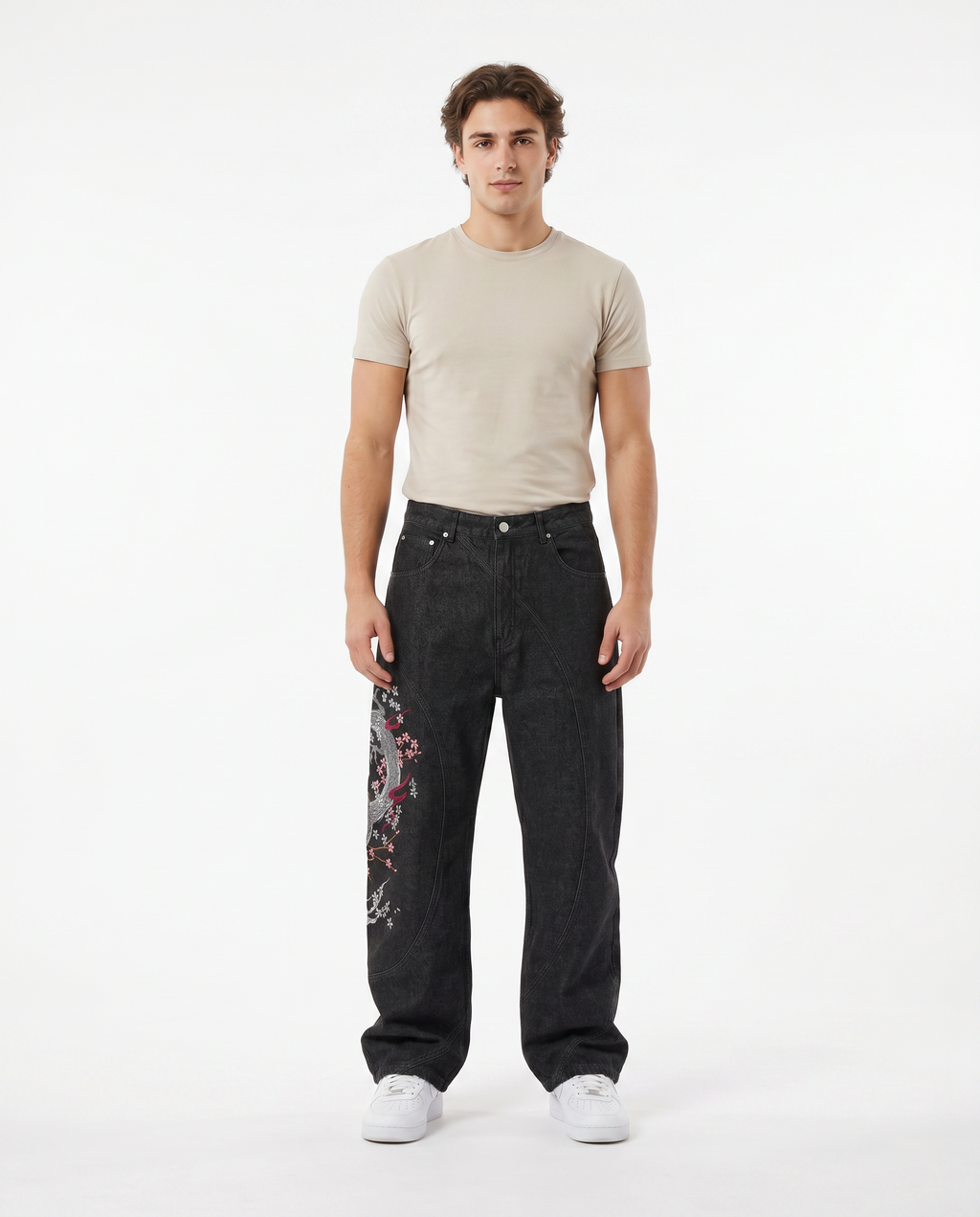 Man wearing embroidered wide-leg baggy jeans in a dark wash