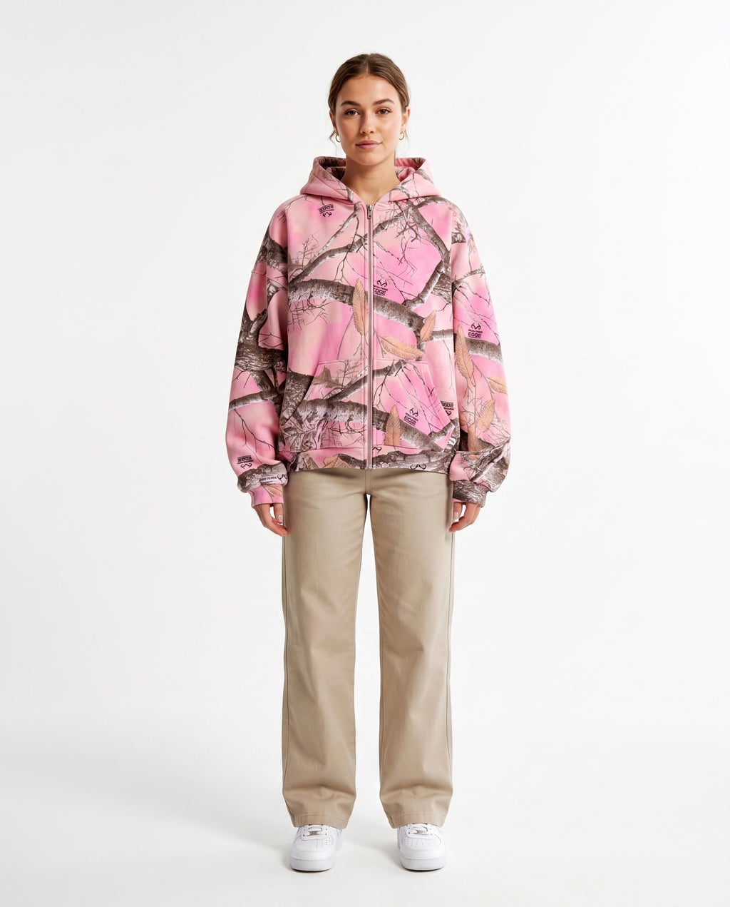 Woman wearing the pink camo zip-up hoodie