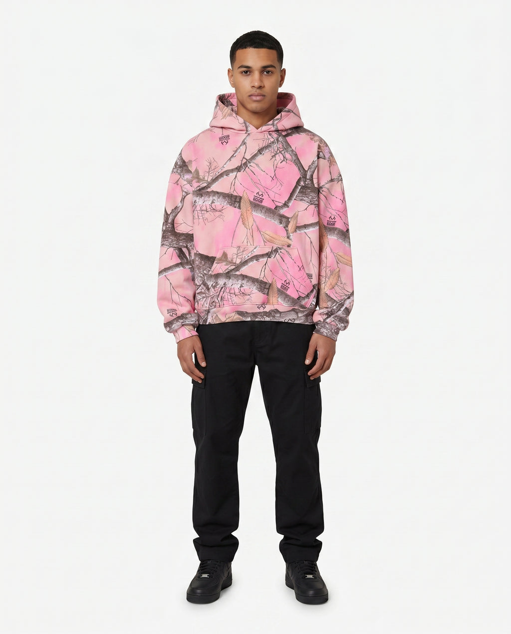 Man wearing the pink camo pullover hoodie, no zip