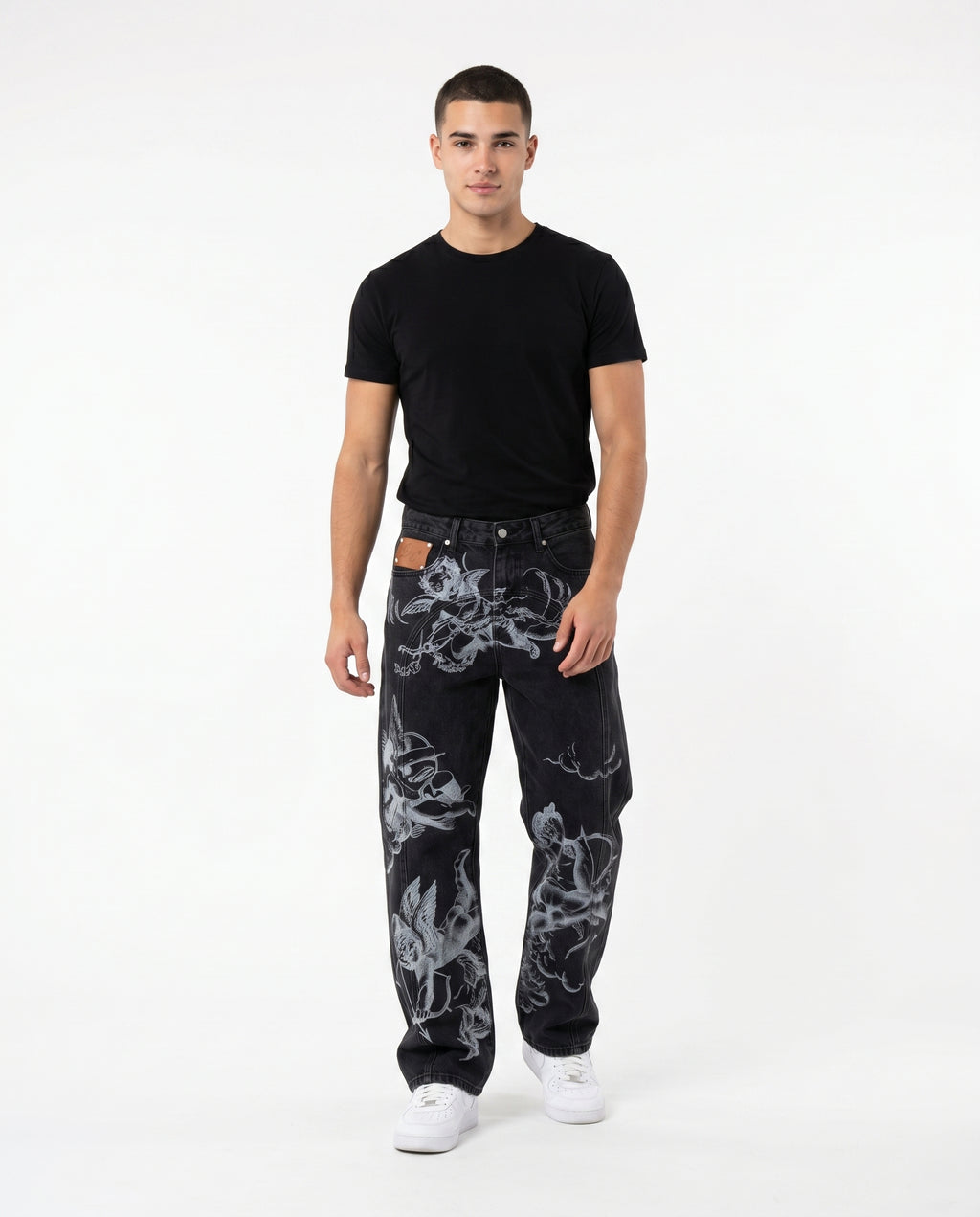 Male model wearing the angel embroidered baggy jeans in black