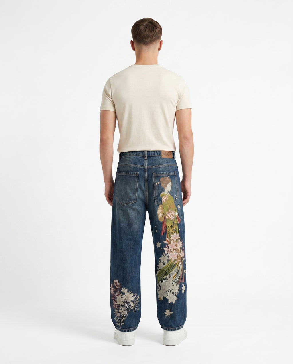 Back view of embroidered baggy Y2K jeans in a mid-tone wash