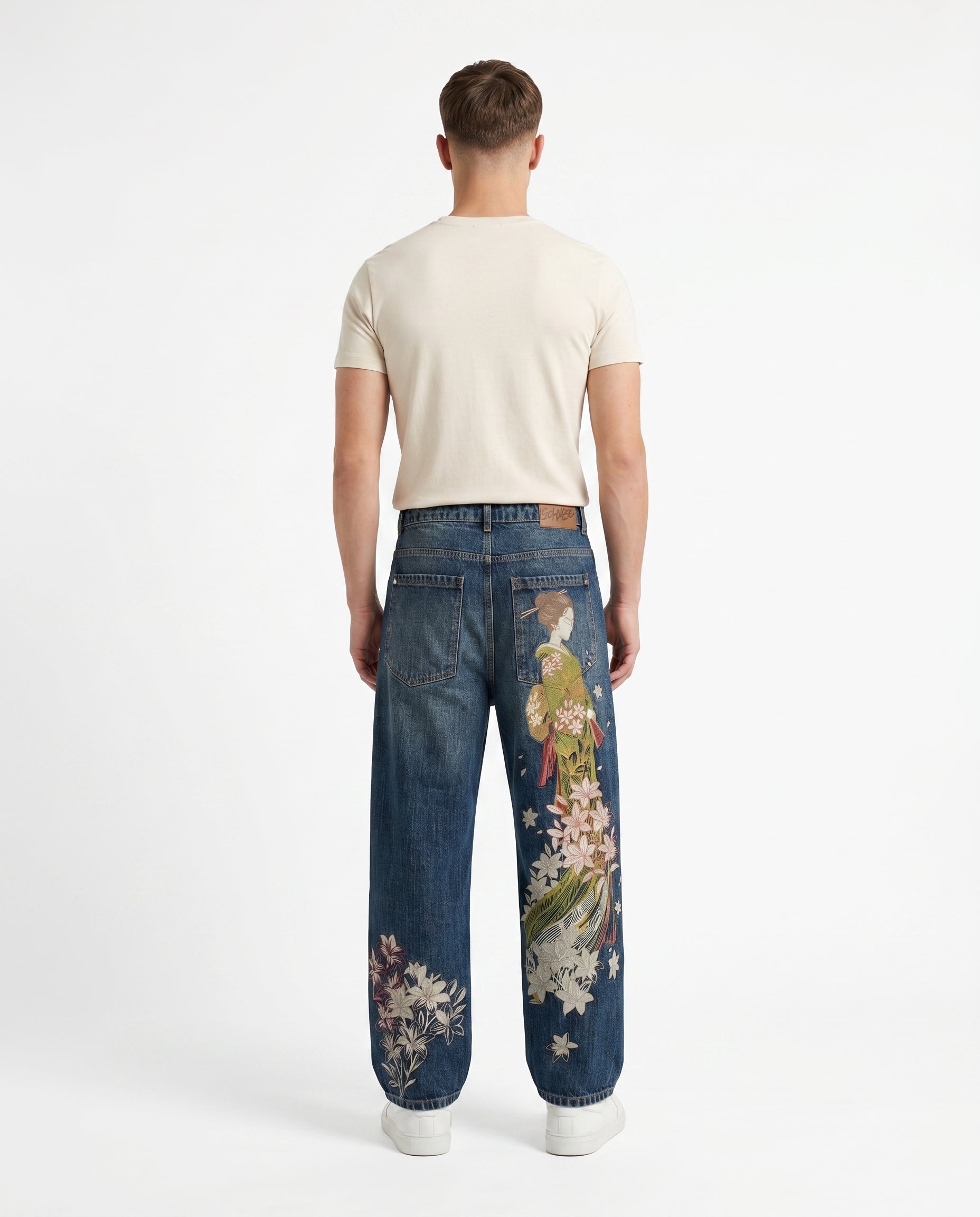 Back view of embroidered baggy Y2K jeans in a mid-tone wash