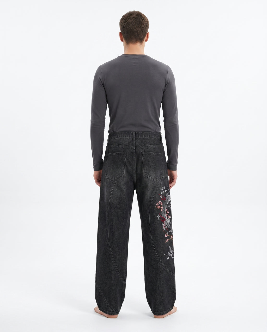 Back view of embroidered baggy jeans in a dark wash