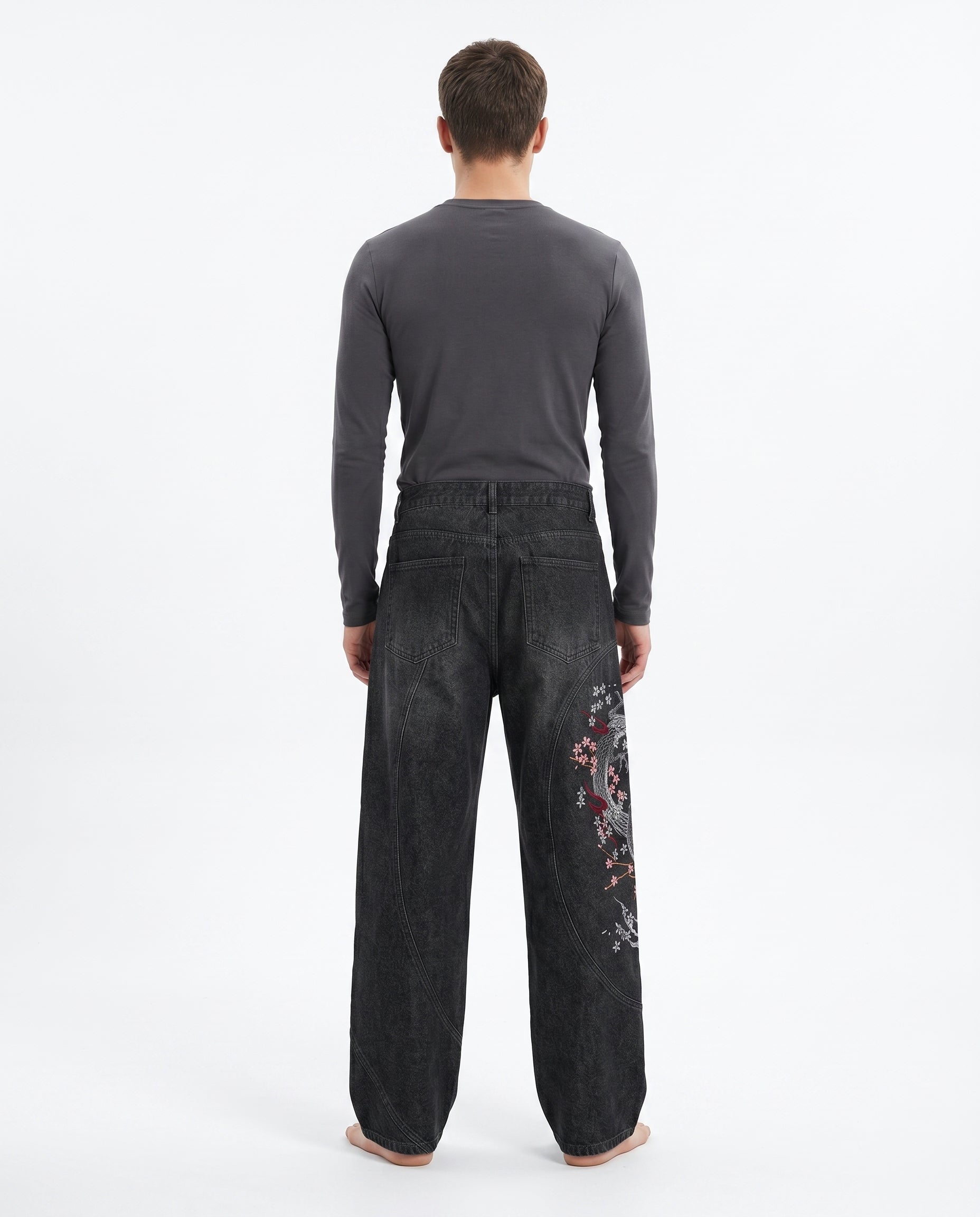Back view of embroidered baggy jeans in a dark wash