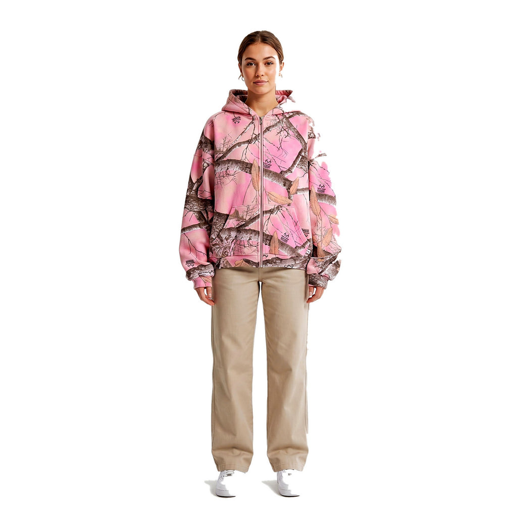 Woman wearing the pink camo zip-up hoodie